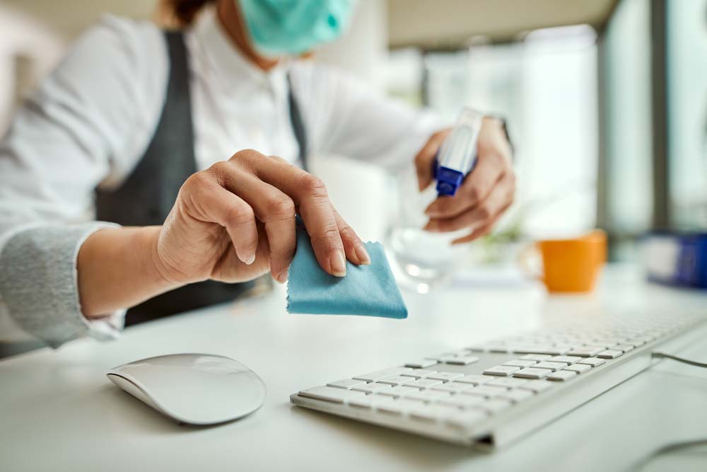A person cleaning office desk