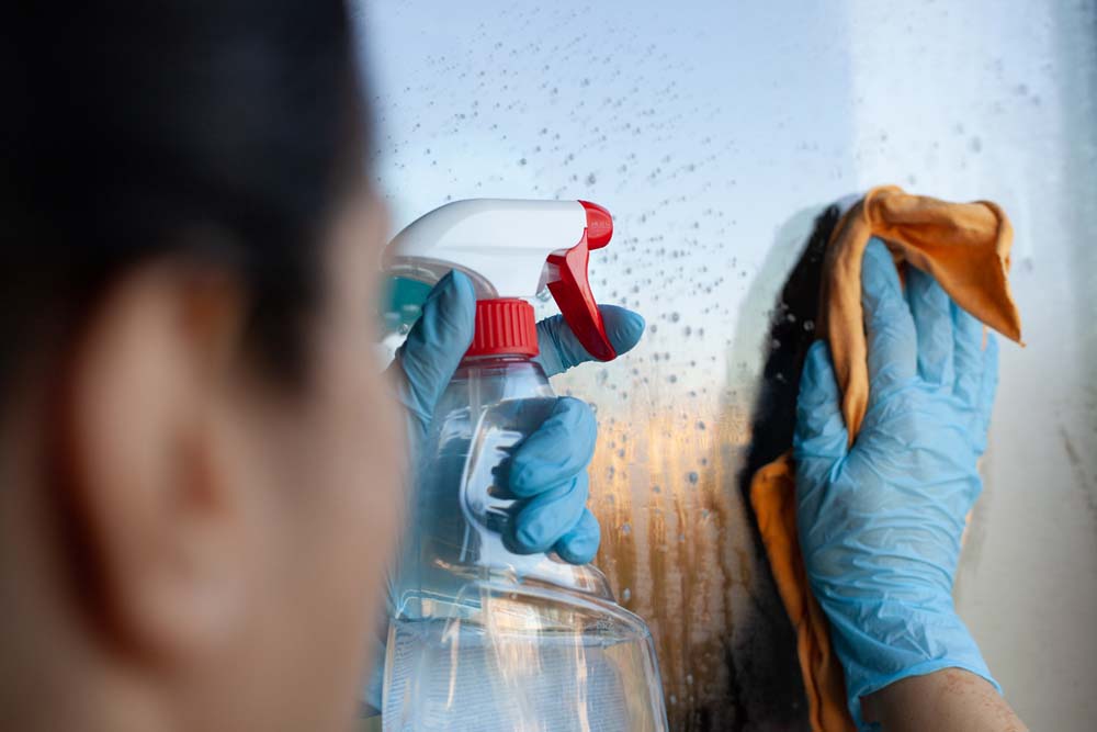 An image of a person cleaning a window